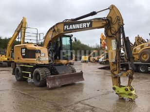 Caterpillar M314F with blade, stabilizers and GP bucket hjulgraver